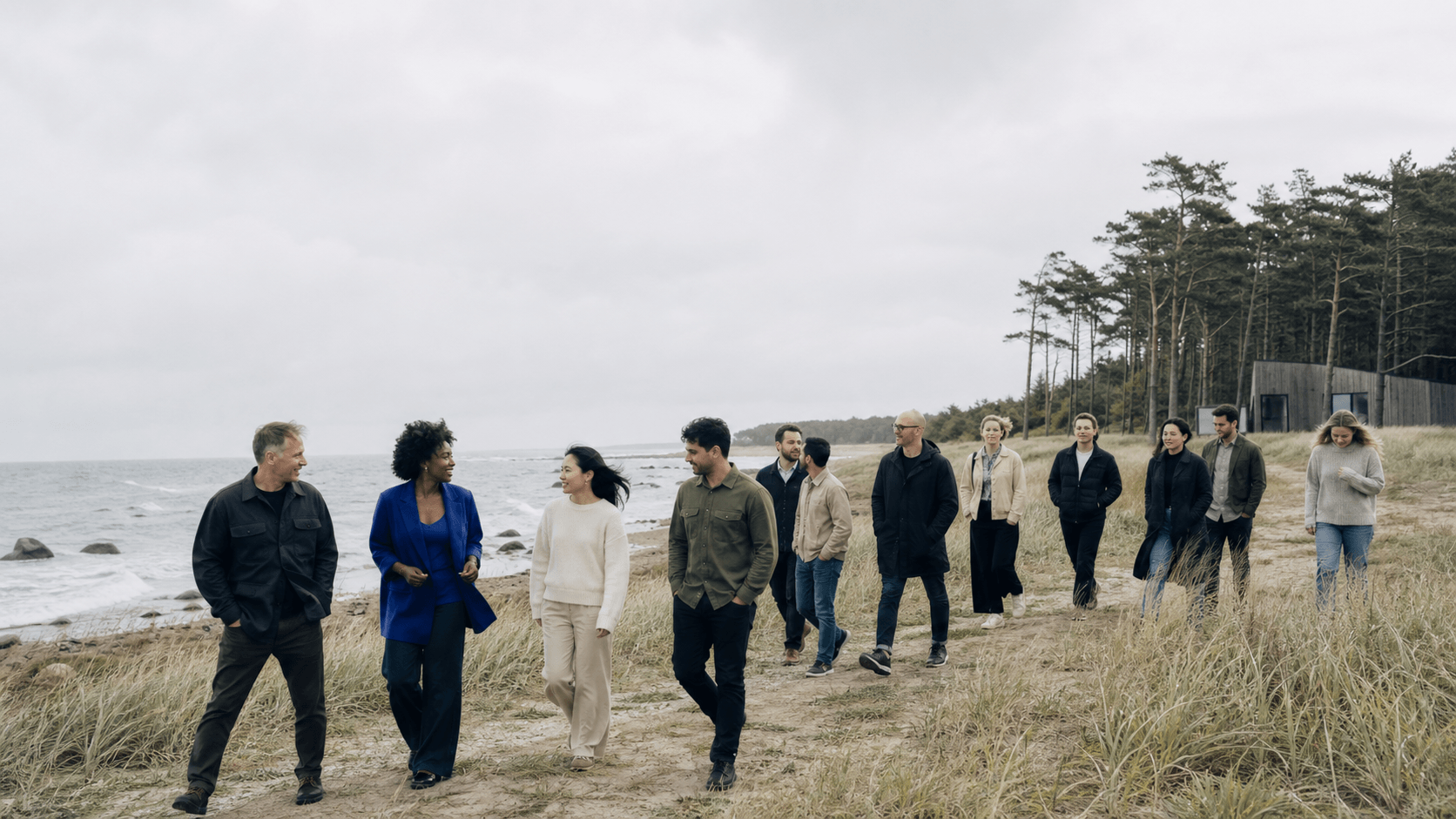 Team walking beside the sea