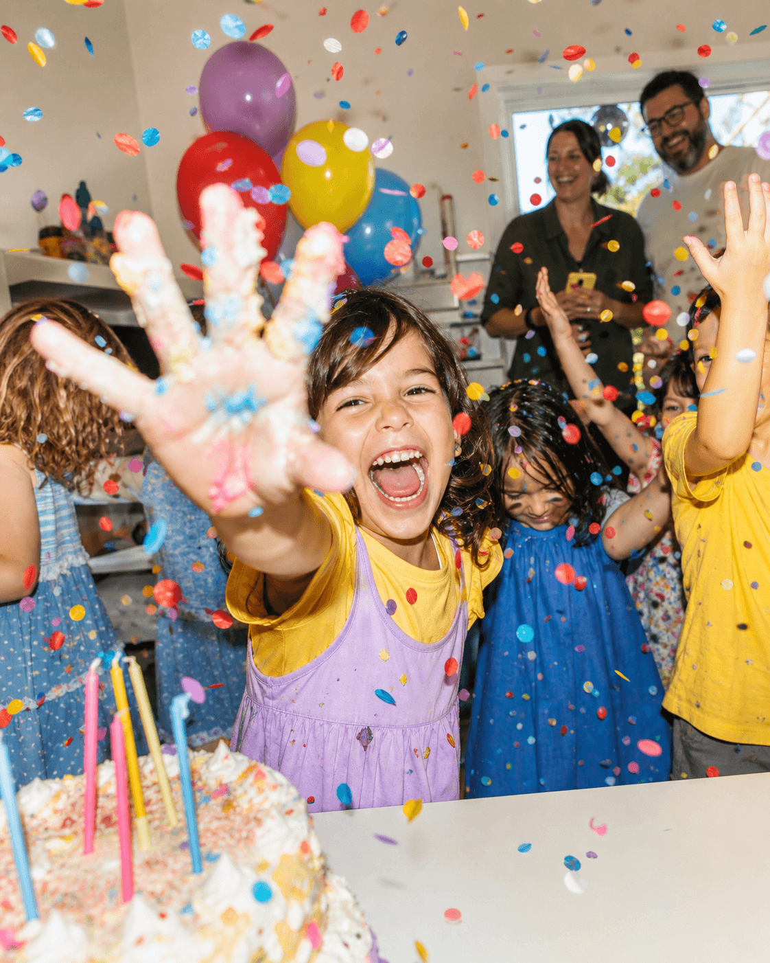 Birthday child celebrating in confetti