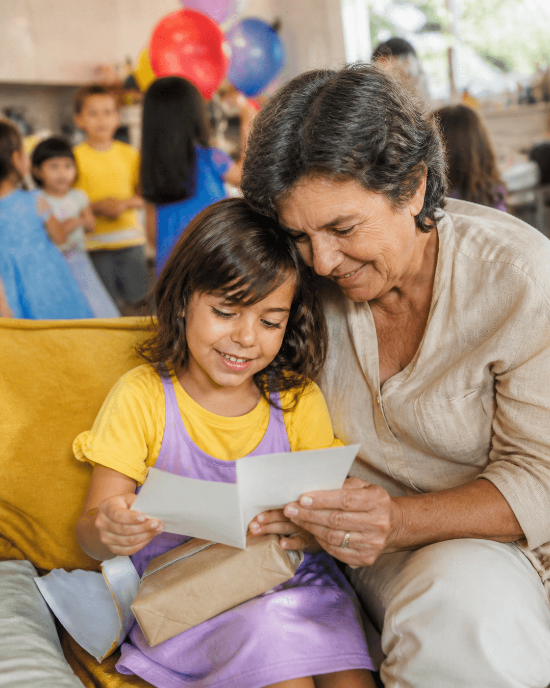 Birthday child reading a card with a grandparent
